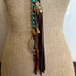 Necklace with turquoise beads and leather tassel.