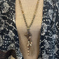 Beaded necklace on patterned fabric.