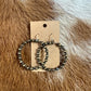 Hoop earrings with small beads on a brown background.