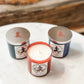 Three scented candles with cowboy boot lids.