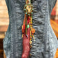 Denim top with ornate pendant necklace.
