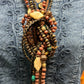 Close-up of a beaded necklace on a denim shirt.