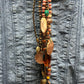 Beaded necklace on blue denim shirt.