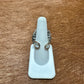 Ring on a white display stand.