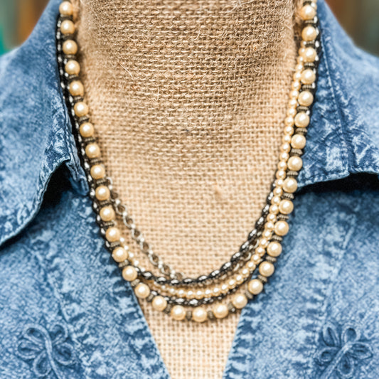 Vintage layered pearl necklace on display