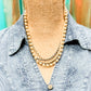 Vintage pearl necklace on denim shirt