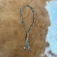 Multi-strand beaded necklace on brown fur.