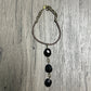 Black beaded necklace on wood