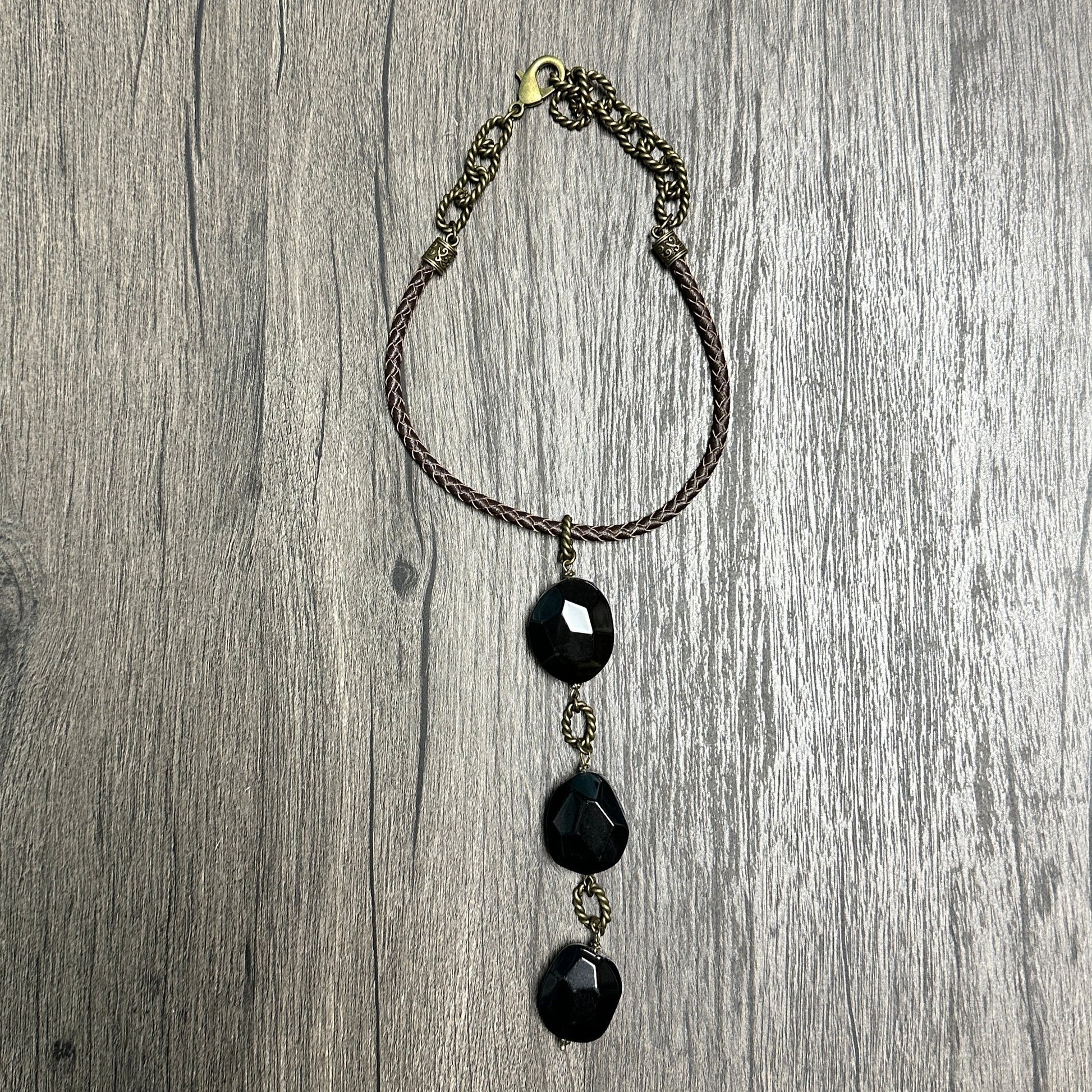 Black beaded necklace on wood