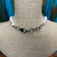 White beaded necklace on a mannequin.