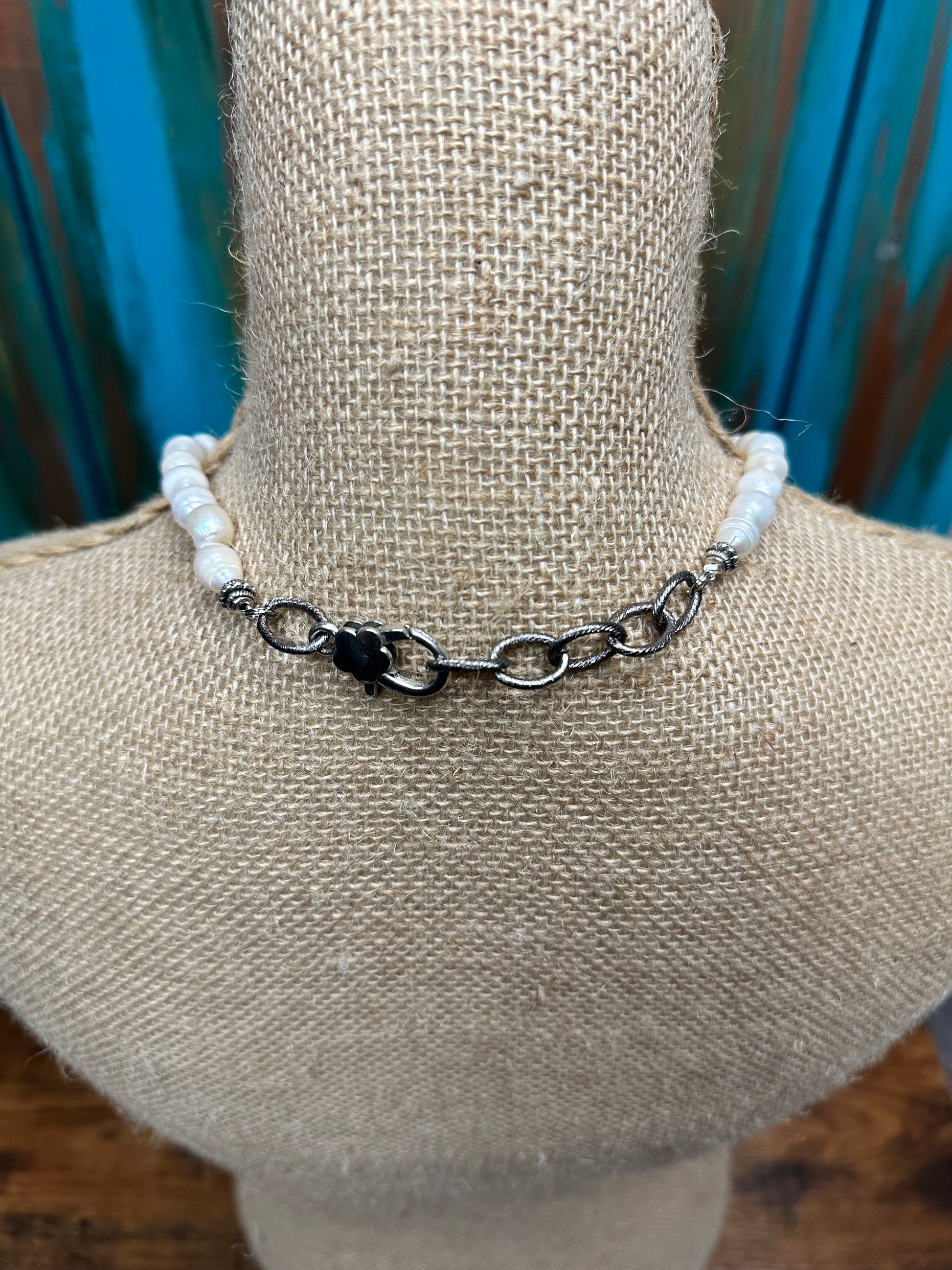 White beaded necklace on a mannequin.