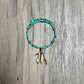 Turquoise beaded bracelet with feather charms.