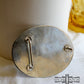 Back of oval silver belt buckle