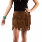 Woman in fringe skirt, black top, and cowboy boots.