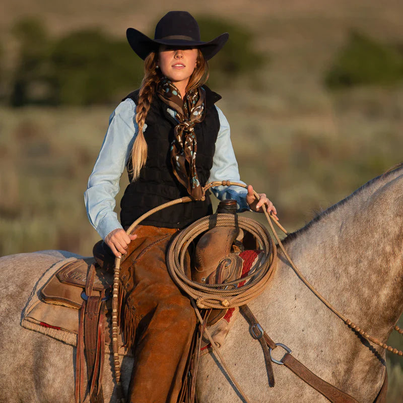 Cowgirl on horseback with rope