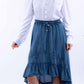 Woman in off-shoulder top & denim skirt