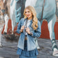 Denim skirt & jacket outfit against mural