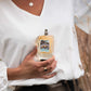Woman holding RodeoSoul perfume bottle