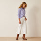 Woman in lavender shirt and white pants