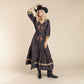 Woman in cowboy hat & embroidered dress.