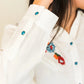White shirt with turquoise buttons