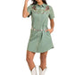 Woman in green cowgirl dress and hat.