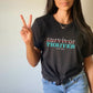 Woman in Survivor Thriver tee showing peace sign