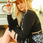 Woman in black shirt and cowboy hat