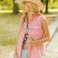 Woman in pink denim vest and hat