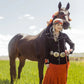 Woman and horse in western attire, wildflowers.