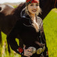 Woman in western wear with horse in field