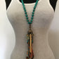 Turquoise beaded necklace on white tank top