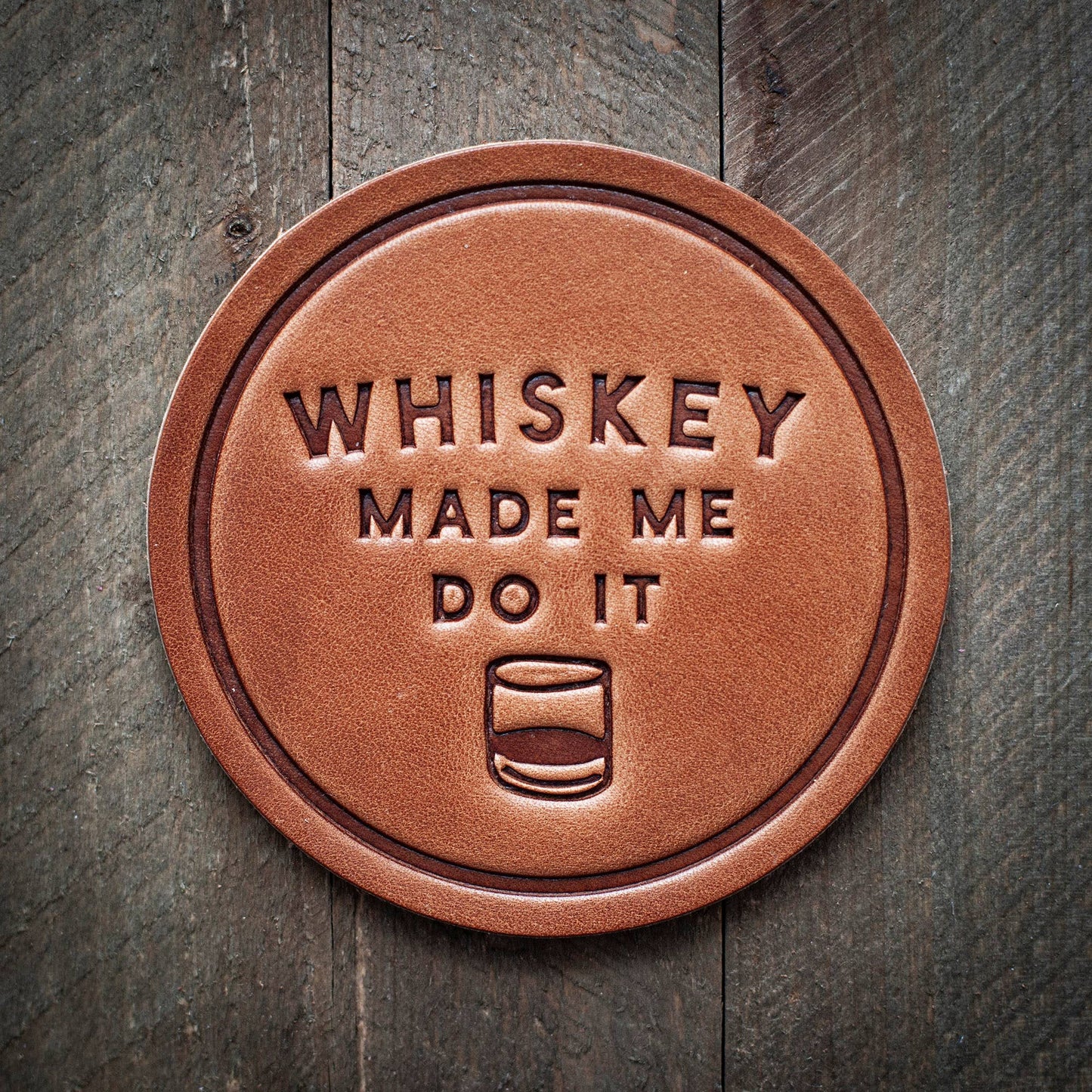 Leather coaster with text.