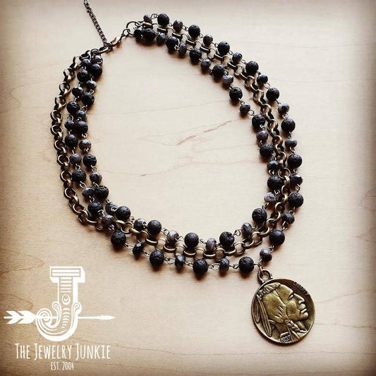 Necklace with black beads and a coin pendant.