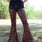 Woman in leopard print pants and black fringe top