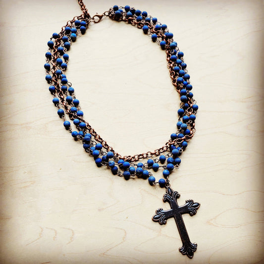 Blue beaded necklace with a cross pendant.