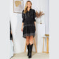 Woman in black dress and boots.