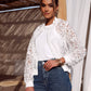 Woman in white lace jacket and jeans