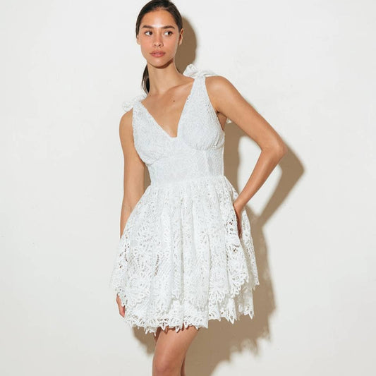 Woman wearing a white lace dress.