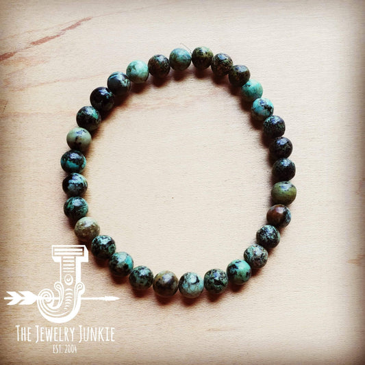Beaded turquoise bracelet on wood.