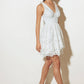 Woman in a white lace dress and heels.