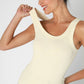 Woman in a cream tank top.