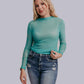 Woman in blue-green top and jeans.