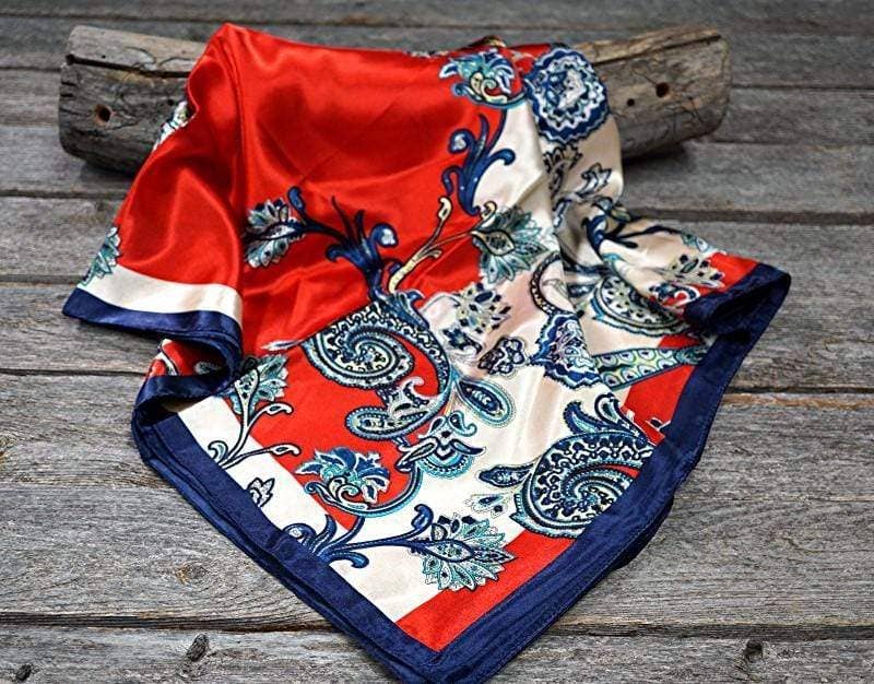 Red, white, and blue patterned silk scarf on wood.