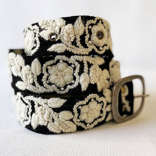 Black belt with white floral embroidery.