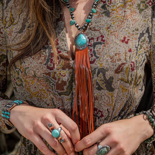 Bohemian lifestyle with turquoise jewelry and leather fringe necklace.