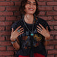 Woman smiling, wearing jewelry and red pants - lifestyle