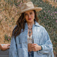 Woman in hat and fringe jacket, lifestyle photo