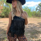 Woman in fringe top and cowboy hat