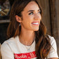 Smiling woman wearing Rockin' B shirt and jewelry